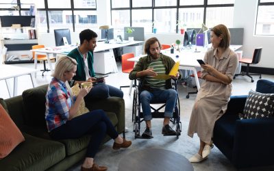 Diverse group of business people working in creative office. group of people in meeting discussing work. business people and work colleagues at a busy creative office.
